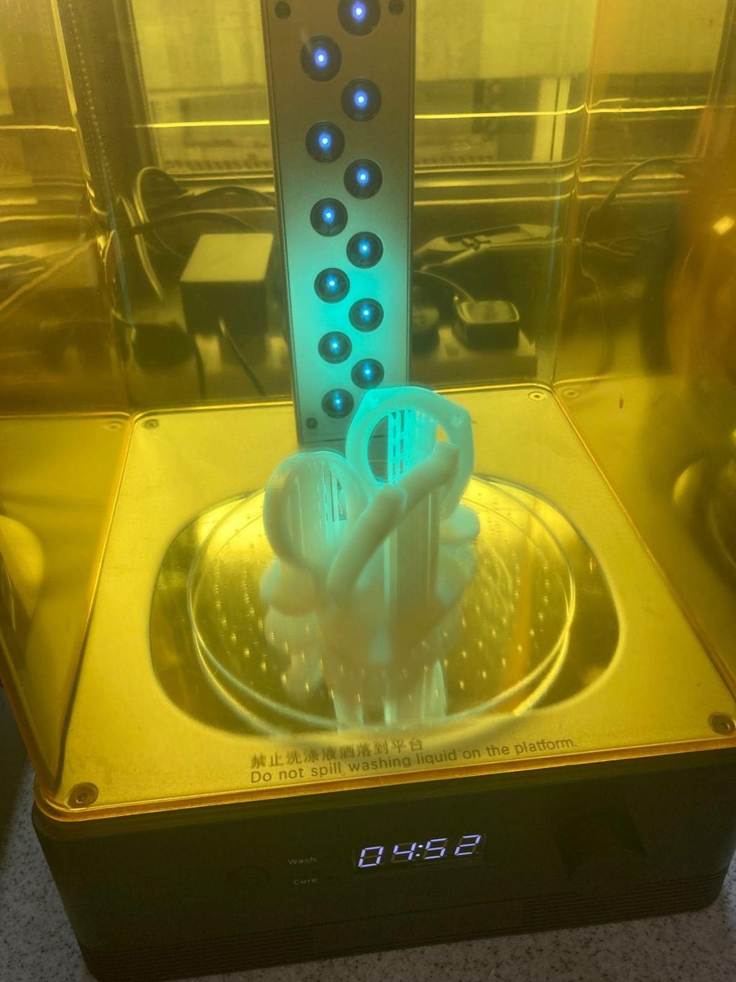 Resin watch parts curing under UV light